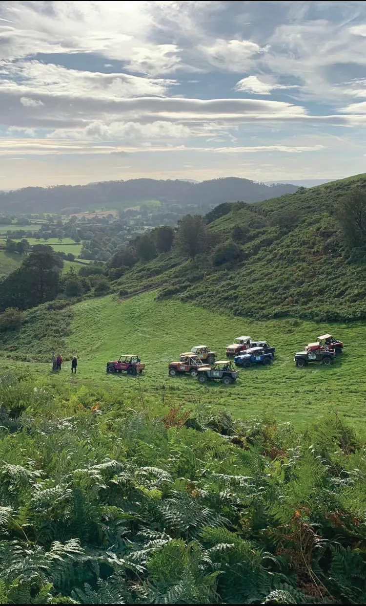 A Land Rover cresting a rise at the Majors